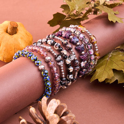 NOGU Maple Glow Collection stack of purple, pink and floral glass bead bracelets with polished silver accents for autumn layering.