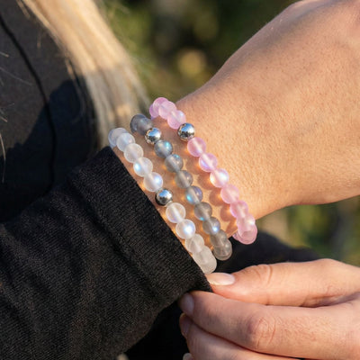 NOGU Made to Pair Rainbow White stack of frosted white, gray, and pink beaded bracelets with silver accents.