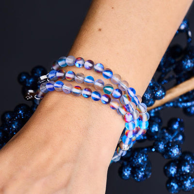 NOGU Mermaid Glass Special Colors bracelet stack with translucent iridescent blue and rainbow glass beads on a wrist.