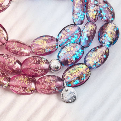 NOGU Firework Pebble Bracelets with pink and purple marbled glass beads, glitter flecks, blue shimmer, and sterling silver charms.