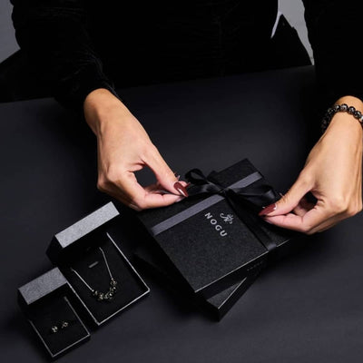 NOGU LIVE Black Friday jewelry gift set with a black beaded bracelet, necklace, earrings, and ribboned box.