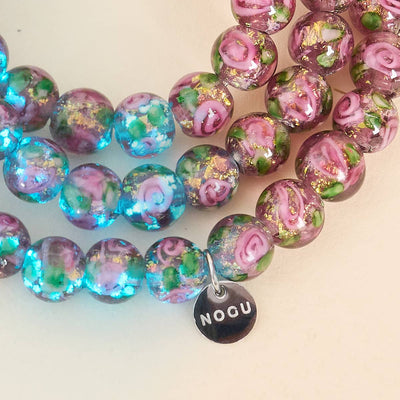 NOGU Firework Flower Bracelets with translucent pink, green and turquoise floral beads, shimmering gold flecks and silver charm.