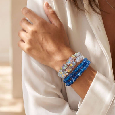 NOGU The Wrap Edit features translucent iridescent and cobalt blue beaded wrap bracelets styled on the wrist.