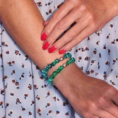 Blue Shamrock Firefly Glass bracelets with green and blue speckled beads and silver clasp on wrist by NOGU