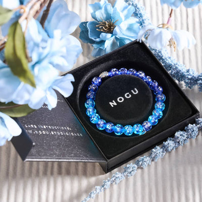 Lapis Lazuli Firefly Glass Bracelet with glowing blue beads in black gift box featuring NOGU logo and .925 sterling silver clasp by NOGU