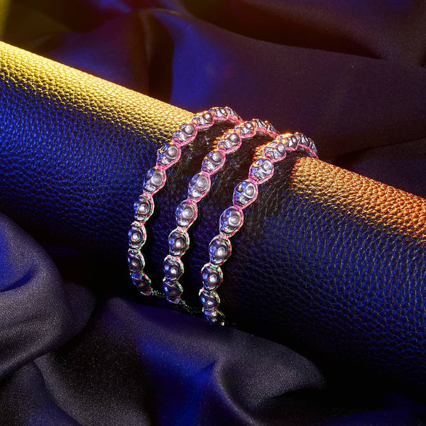 Silver hematite skull macrame bracelet with a pink glow-in-the-dark adjustable cord, styled around a black textured cuff.
