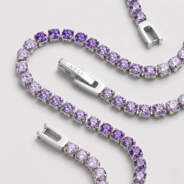 Rhodium-finish stainless steel tennis bracelet with violet ombré crystals and a polished hinged clasp.
