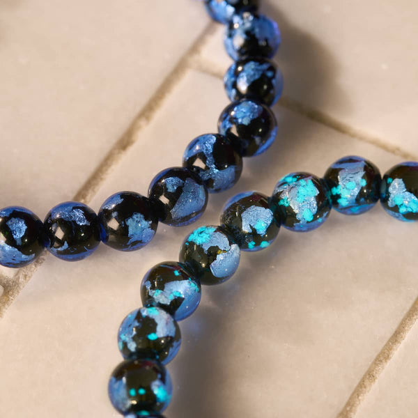 Azure Eclipse Lunar Glass stretch bracelet with glossy deep blue beads and luminous turquoise flecks.