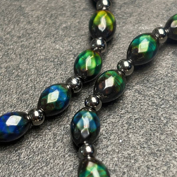 Chromata Fabergé stretch bracelet with oval color-changing mood stone beads in green, teal, blue and yellow, accented by silver beads.