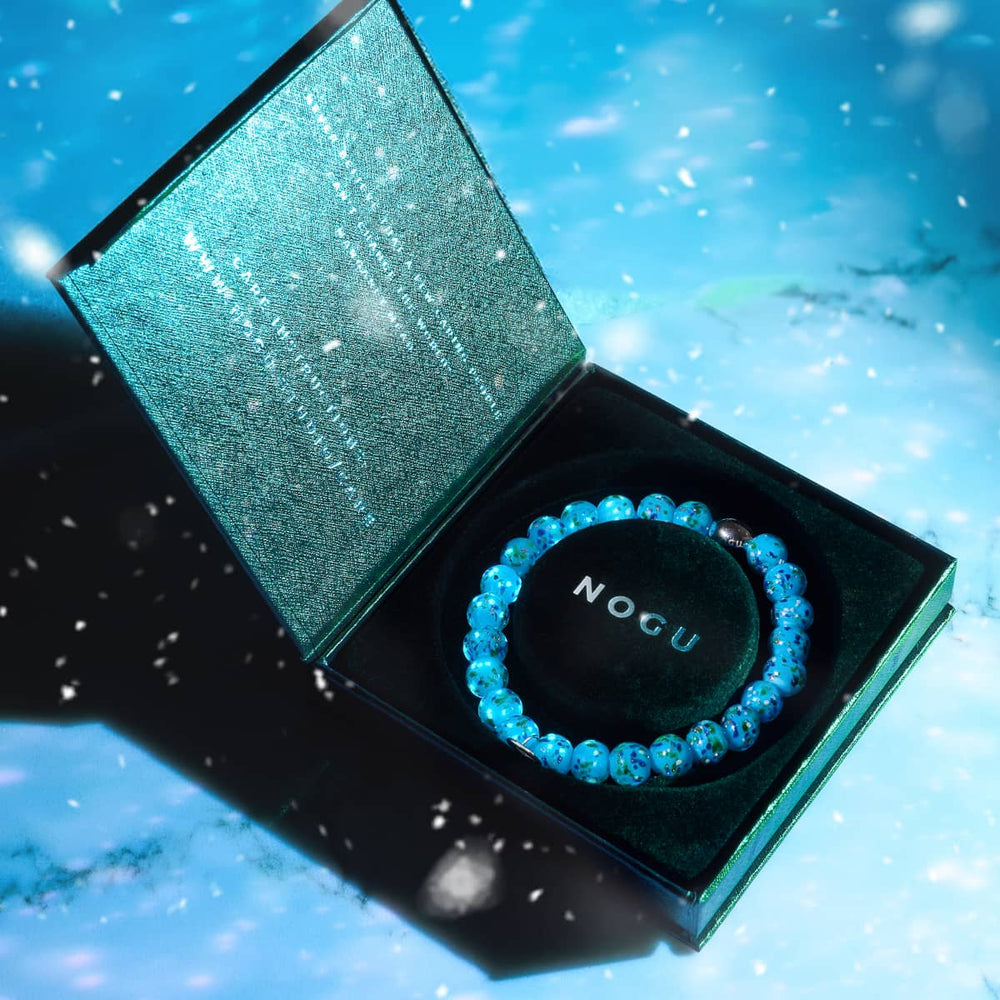 Blue Juniper Firefly Glass Bracelet with blue speckled beads in black gift box with NOGU logo by NOGU